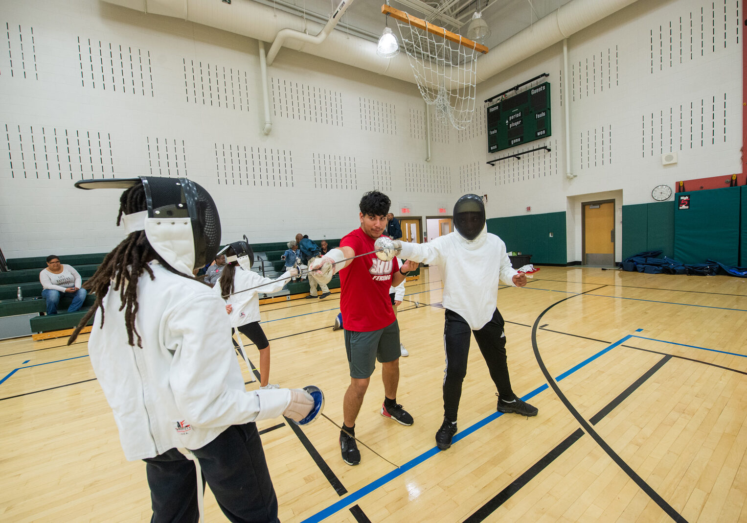 Sacred Heart University’s NCAA Division I fencing team has embarked on a collaboration with The Willie and Sandra McBride Foundation, which has started a fencing program for middle school students in Bridgeport. The team worked with children at the Fairchild Wheeler Interdistrict Magnet School during a recent training session. Sacred Heart University photo by Tracy Deer-Mirek 10/6/22