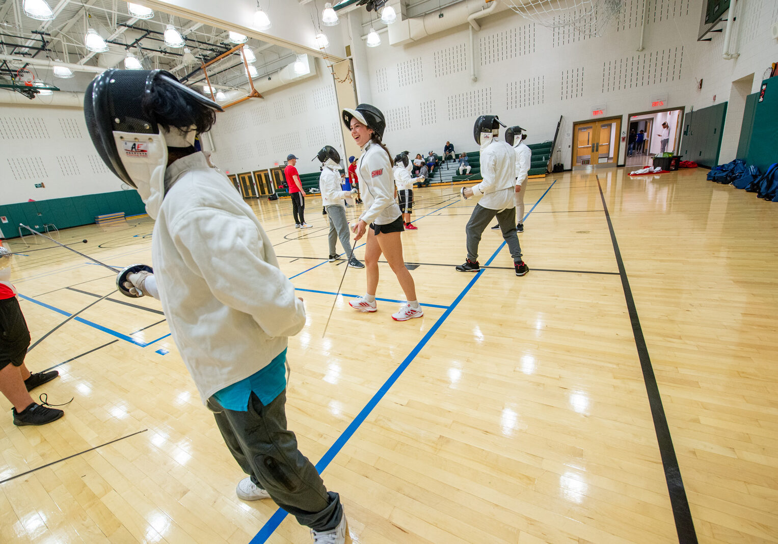 Sacred Heart University’s NCAA Division I fencing team has embarked on a collaboration with The Willie and Sandra McBride Foundation, which has started a fencing program for middle school students in Bridgeport. The team worked with children at the Fairchild Wheeler Interdistrict Magnet School during a recent training session. Sacred Heart University photo by Tracy Deer-Mirek 10/6/22